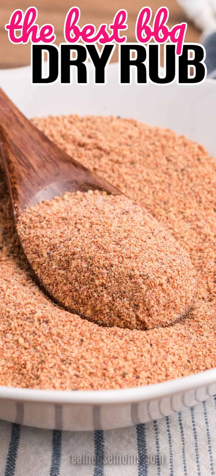 the best bbq dry rub in a white bowl with a wooden spoon on top