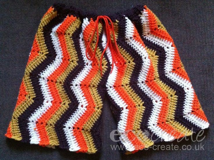 an orange, white and black crocheted shorts