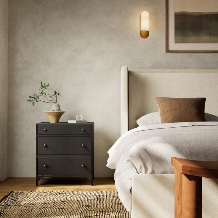 a bedroom scene with focus on the bed and nightstand, which has a plant on it