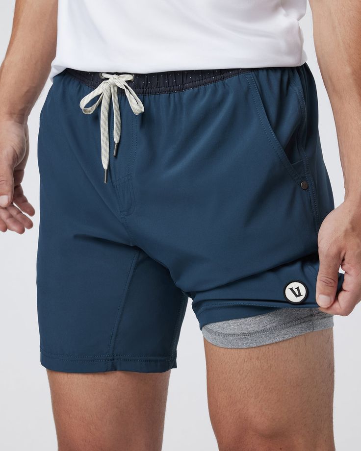 One short for every sport, the Kore Shorts have a classic athletic fit, falling just above the knee with an anywhere and everywhere versatility. Go commando in confidence with the breathable, boxer-brief liner.Also available in 5" and 9" inseam. | Vuori Kore Shorts | Indigo | XXL Vuori makes premium performance apparel inspired by the active Coastal California lifestyle; an integration of fitness, surf, sport, and art. Breaking down the boundaries of traditional activewear, we are a new perspect Outdoor Compressive 2-in-1 Bottoms, Casual Sports Boxer Briefs With Comfort Waistband, Navy Activewear With Built-in Shorts For Gym, Outdoor Compression Athletic Shorts With Built-in Shorts, Compressive Athletic Shorts With Built-in Shorts For Outdoor, Navy Functional Shorts, Compressive Shorts With Built-in Shorts For Outdoor, Navy Activewear With Built-in Shorts For Training, Sports Nylon Boxer Briefs With Built-in Shorts