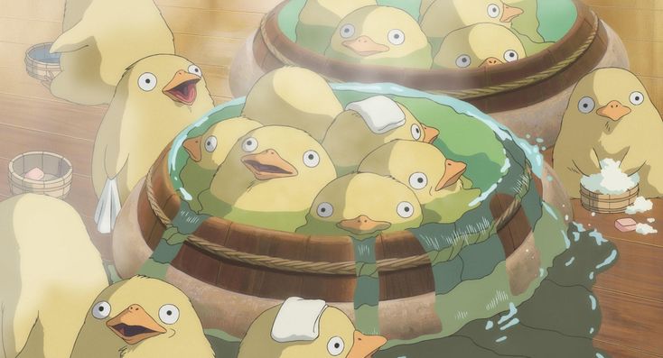 a bunch of birds that are standing in the water near some buckets filled with food