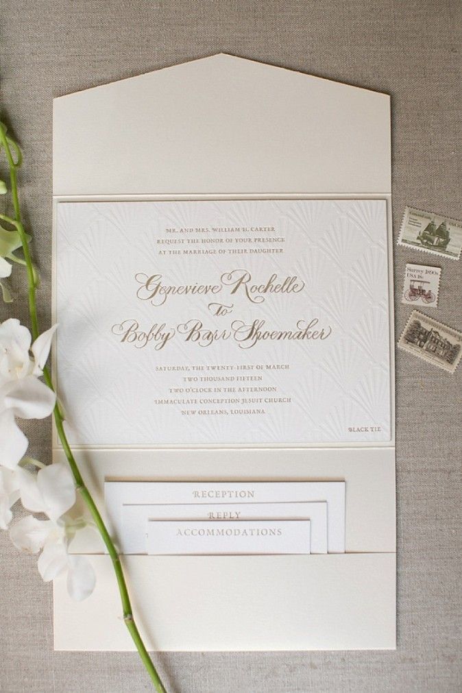 the wedding stationery is laid out next to some flowers