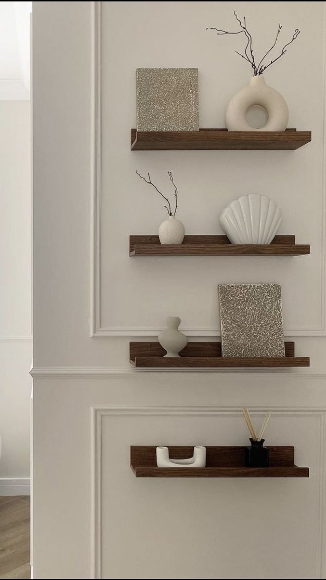 three wooden shelves with decorative items on them