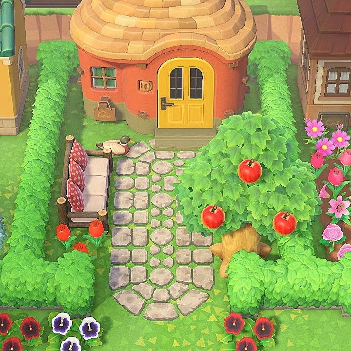 a small house surrounded by flowers and trees in the middle of a garden with an orange door