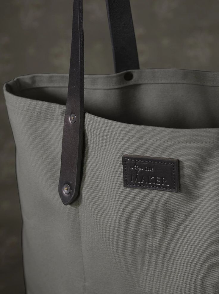 The ultimate carry-all, this sturdy cotton canvas tote with thick leather straps and inside pocket, is functional and durable. The extra-long handles make it super comfortable to carry over shoulders, and fits our everyday essentials, including a laptop.  What we love about it We first discovered Detroit Denim when we Waxed Canvas Bag With Leather Handles For On-the-go, Everyday Waxed Canvas Shoulder Bag With Leather Handles, Double Handle Cotton Canvas Bag For Travel, On-the-go Canvas Bag With Reinforced Handles, Casual Cotton Canvas Bag With Waxed Finish, Leather Canvas Bag With Canvas Lining For On-the-go, Practical Everyday Bag With Leather Trim, Everyday Coated Canvas Bag With Reinforced Handles, Everyday Duck Canvas Bag With Double Handle