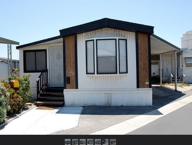 a mobile home sits in front of some houses