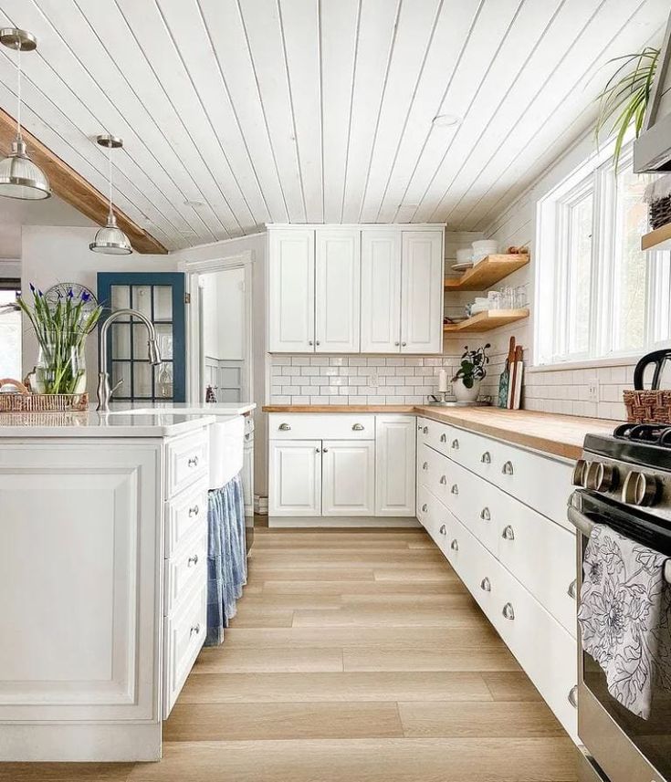 the kitchen is clean and ready for us to use it's white cabinetry