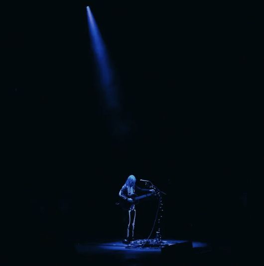 a person standing on a stage in the dark