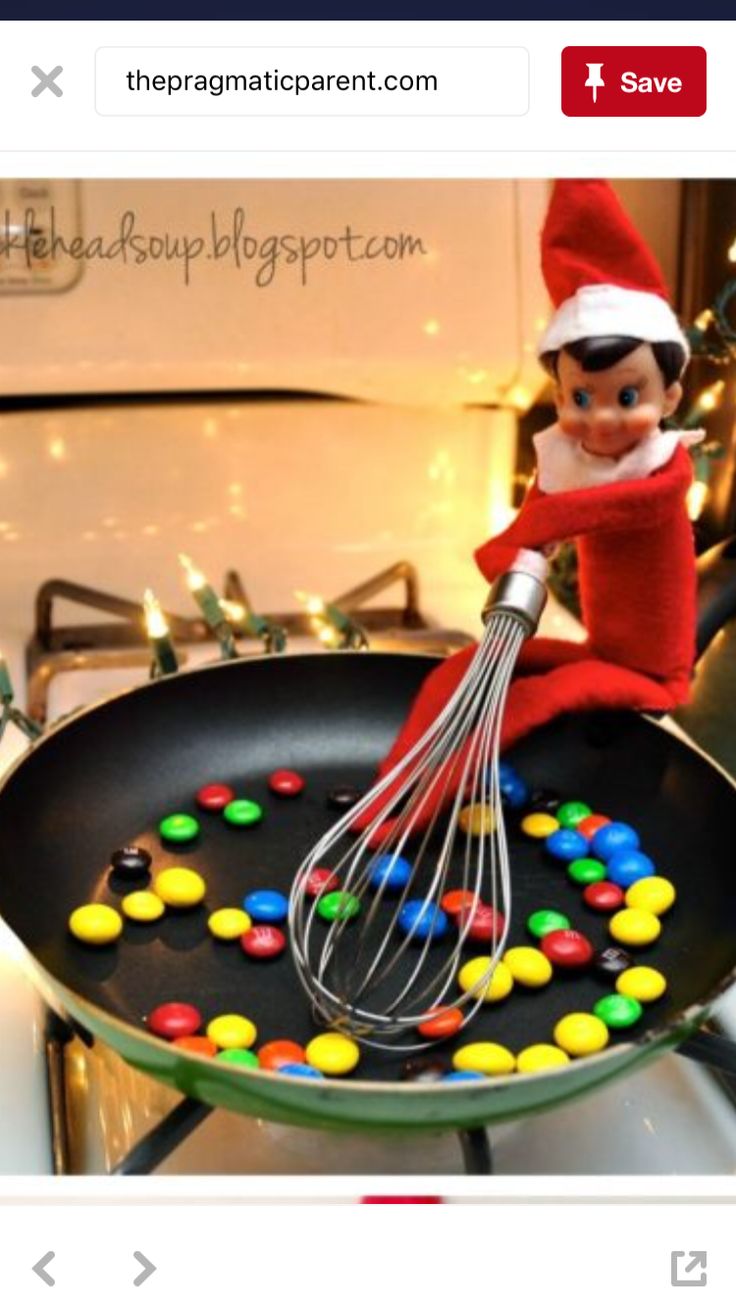 an elf is cooking candy in a frying pan with a whisk on it