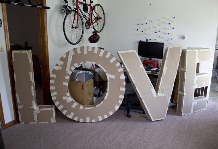 the word love spelled out in front of a computer desk with a bike mounted to it