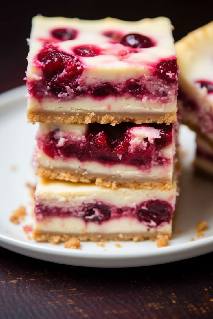 three pieces of dessert sitting on top of a white plate