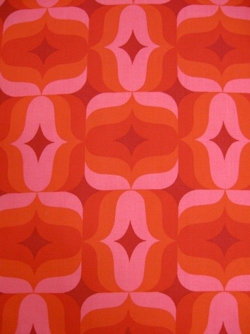 an orange and pink pattern on fabric