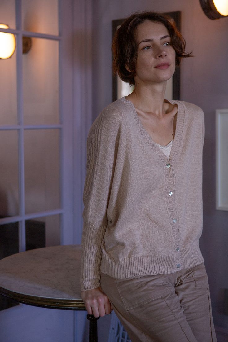 The sweater you'll never want to take off. Knit in a lightweight soft beige pima cotton with blush undertones, our best-selling box cardigan features fitted, ribbed sleeves and beautiful shell button closures. The relaxed fit is ideal for layering or simply wearing on its own. Knit on manual machines in Bolivia and finished by hand. Erica Tanov Details Made in Bolivia. 100% Pima Cotton. Hand wash cold and dry flat. Elegant Everyday Cardigan With Relaxed Fit, Spring Solid Cashmere Cardigan, Solid Cashmere Cardigan For Spring, Elegant Beige Relaxed Fit Cardigan, Classic Neutral Cardigan For Layering, Beige Ribbed Cardigan For Layering, Elegant Soft Knit Everyday Cardigan, Elegant Cashmere Cardigan With Relaxed Fit, Elegant Everyday Soft Knit Cardigan