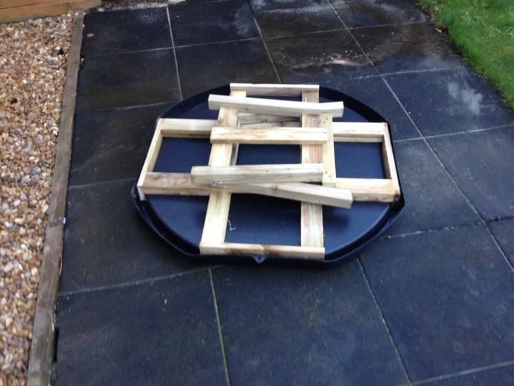 a blue plate sitting on top of a black tile floor next to a green grass covered yard