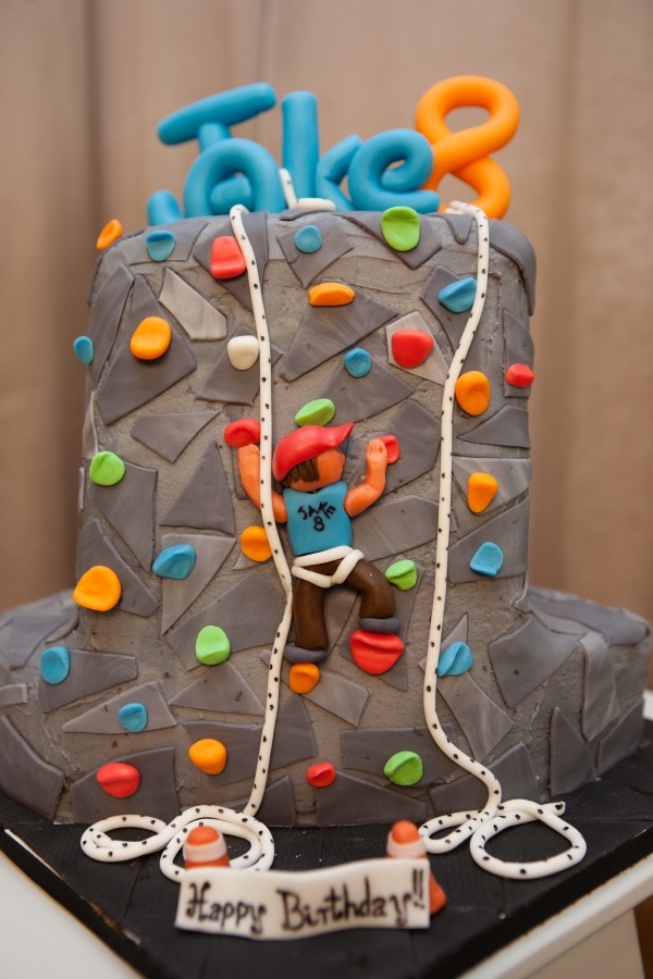 a decorated birthday cake with an image of a climber on it