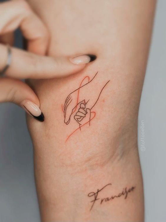 a woman's arm with a small tattoo on it