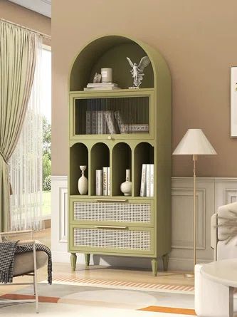 a living room with a green bookcase in the corner