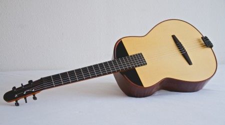 an ukulele is sitting upright on a white surface