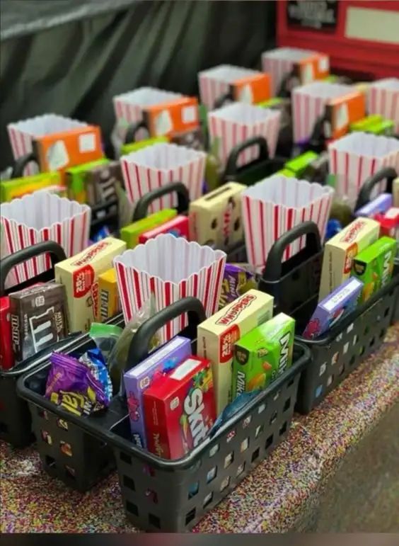 several baskets filled with different types of snacks and candy bars on top of a table