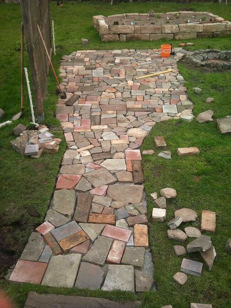 a stone path in the middle of a yard