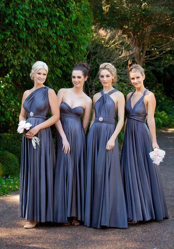 four bridesmaids in blue dresses posing for the camera