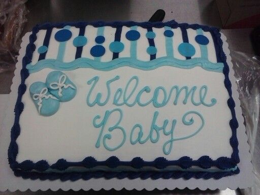 a welcome baby cake with blue and white decorations