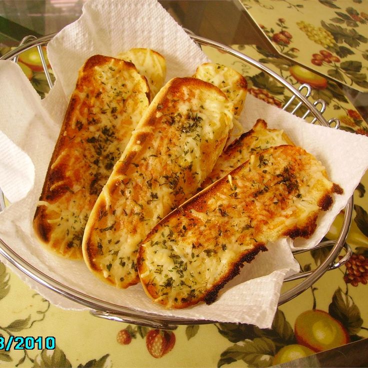 four slices of pizza on a plate with napkins and silver serving utensils