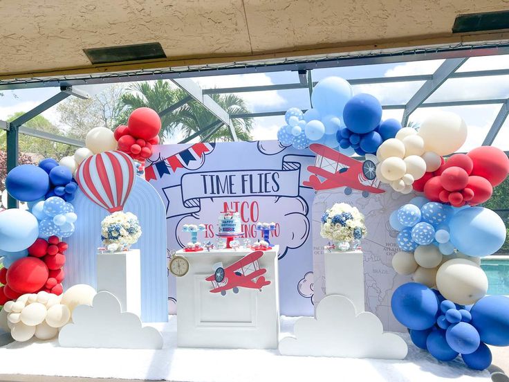 an airplane themed birthday party with balloons and streamers on the front entrance to a pool