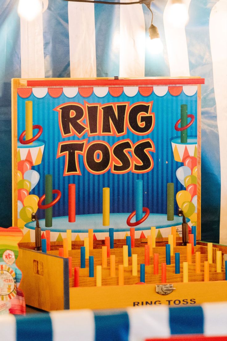 a ring toss game set up in front of a circus tent