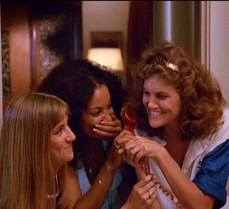 three women smile as they brush their teeth