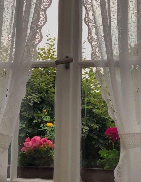 the window is open and there are flowers outside