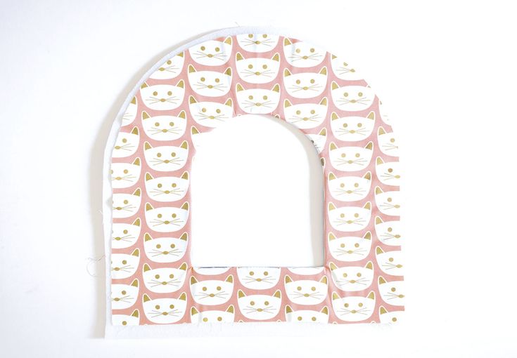 a white and pink arch with cats on it