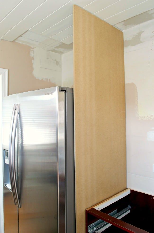 a metallic refrigerator freezer sitting inside of a kitchen