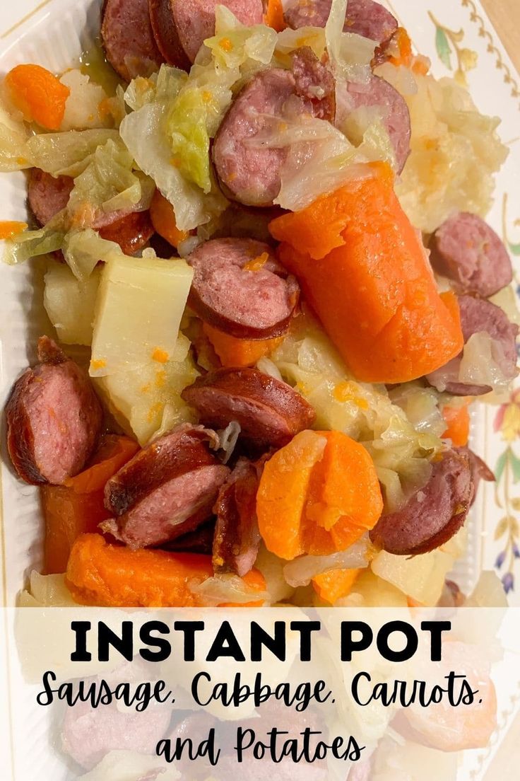 a white plate topped with sausage, cabbage and carrots