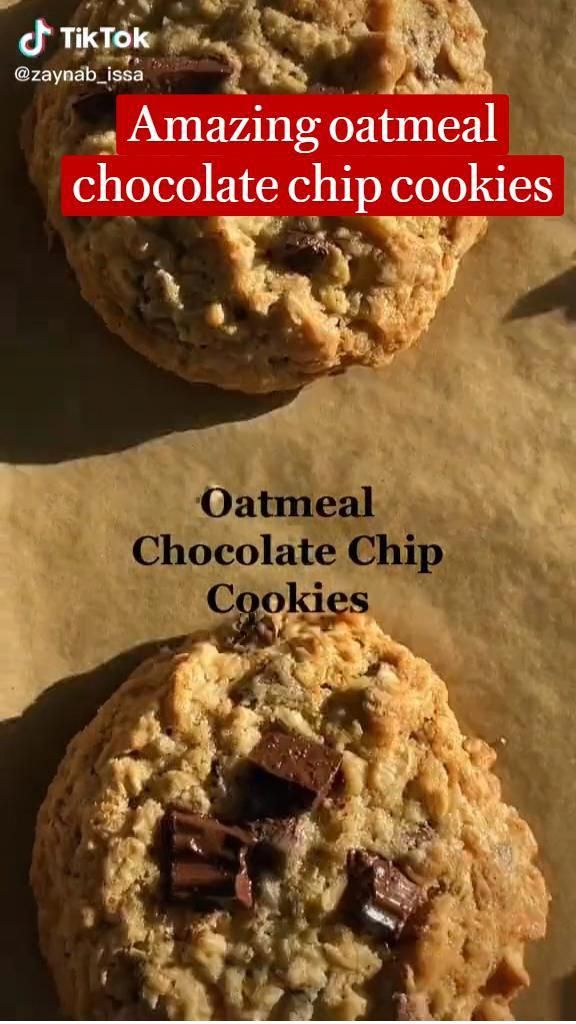 two chocolate chip cookies sitting on top of parchment paper with the words amazing oatmeal chocolate chip cookies