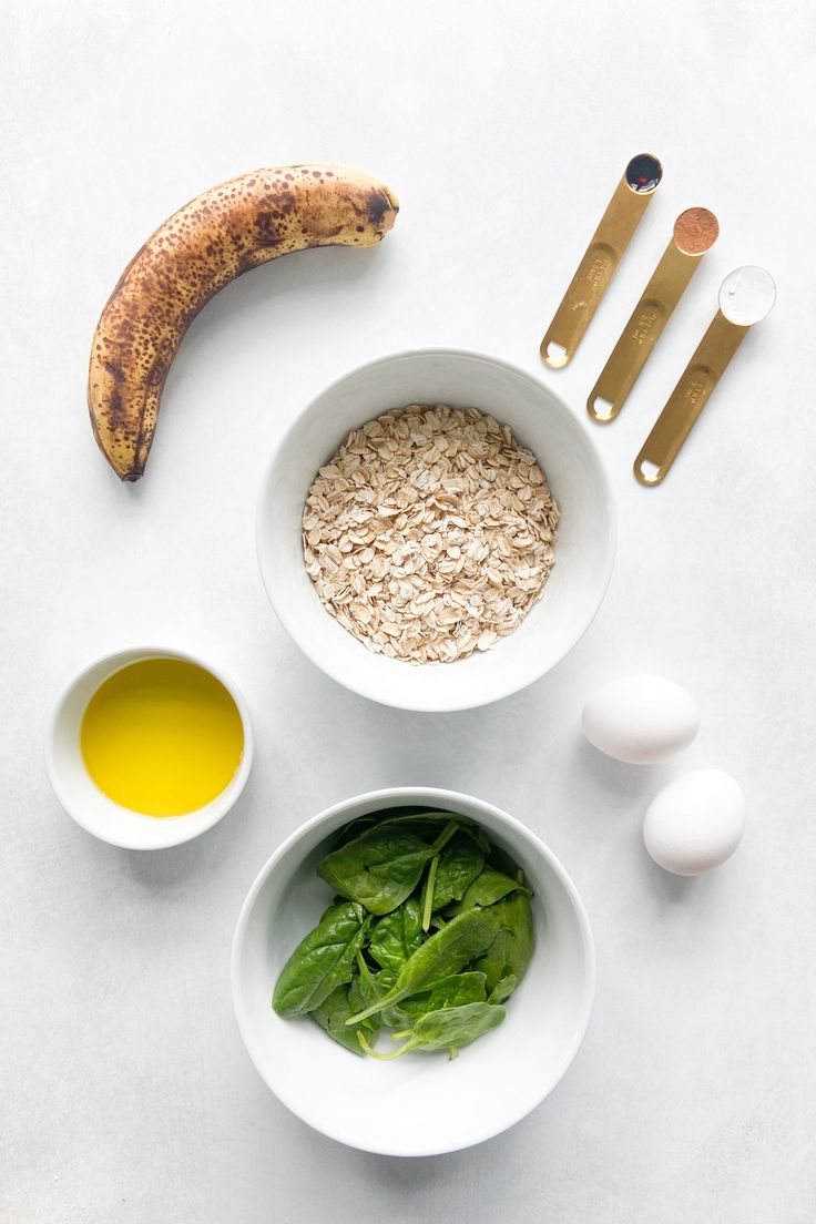 ingredients to make an oatmeal smoothie laid out on a white surface