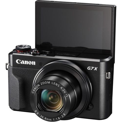 a digital camera sitting on top of a white surface