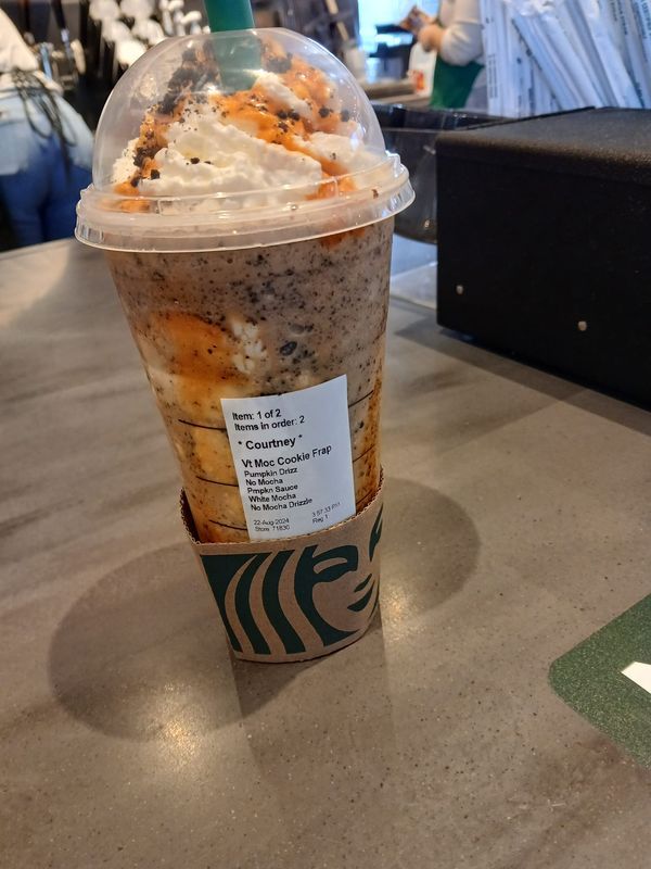 a starbucks coffee cup sitting on top of a table