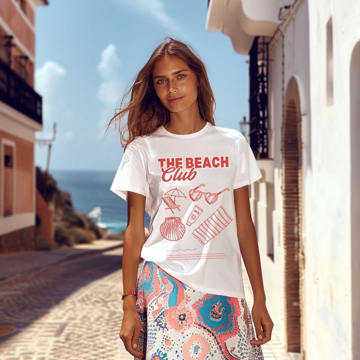 Get ready for sunny days with our soft style t-shirt featuring trendy retro doodles of beach icons like sunglasses, beach towels, beach chairs, and more. With "The Beach Club" proudly displayed, this shirt captures the playful and carefree spirit of beach life. Product Features: -Material: Made from 100% ring-spun cotton, this lightweight fabric (4.5 oz/yd² or 153 g/m²) ensures a comfortable wear all year round. -Design: The retro doodles and distressed printing give the t-shirt a unique, vintage appeal that's perfect for beach lovers. Fit: With a classic fit and crew neckline, this shirt offers a clean, versatile style suitable for any occasion, whether casual or semi-formal. -Durability: The shoulders feature twill tape for improved durability, and the ribbed knitting on the collar preve Graphic Print Beach Shirt For Summer, White Fun Summer Shirt, Fun White Summer Shirt, Poolside Crew Neck Tops For Beachwear, Summer Short Sleeve Tops For Poolside, Crew Neck Tops For Poolside Beachwear, Crew Neck Beachwear Tops For Poolside, Short Sleeve Tops For Poolside Summer, White Beachwear Top For Vacation