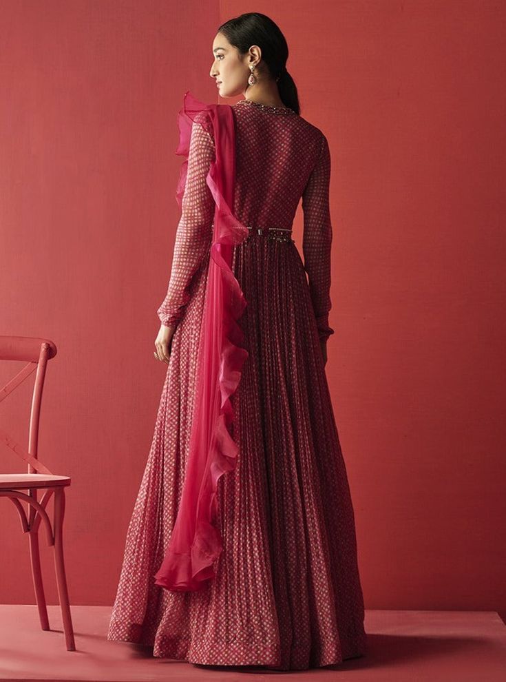 Editor's Note Make a bold statement with this stunning set featuring a deep fuschia chiffon folk printed anarkali. The intricate embroidery and delicate net detailing of the dupatta add an elegant touch to this beautiful ensemble. The set is completed with an embroidered jeweled belt to accentuate your curves and add a touch of glamor to your overall look. Perfect for any formal occasion or event, this set is sure to turn heads and make you stand out from the crowd. Color: Fuschia Fabric: Chiffo Deep Fuschia, Ruffle Dupatta, Ridhi Mehra, Folk Print, Choli Dress, Printed Anarkali, Ruffle Saree, Embellished Belt, Embroidered Crop Tops