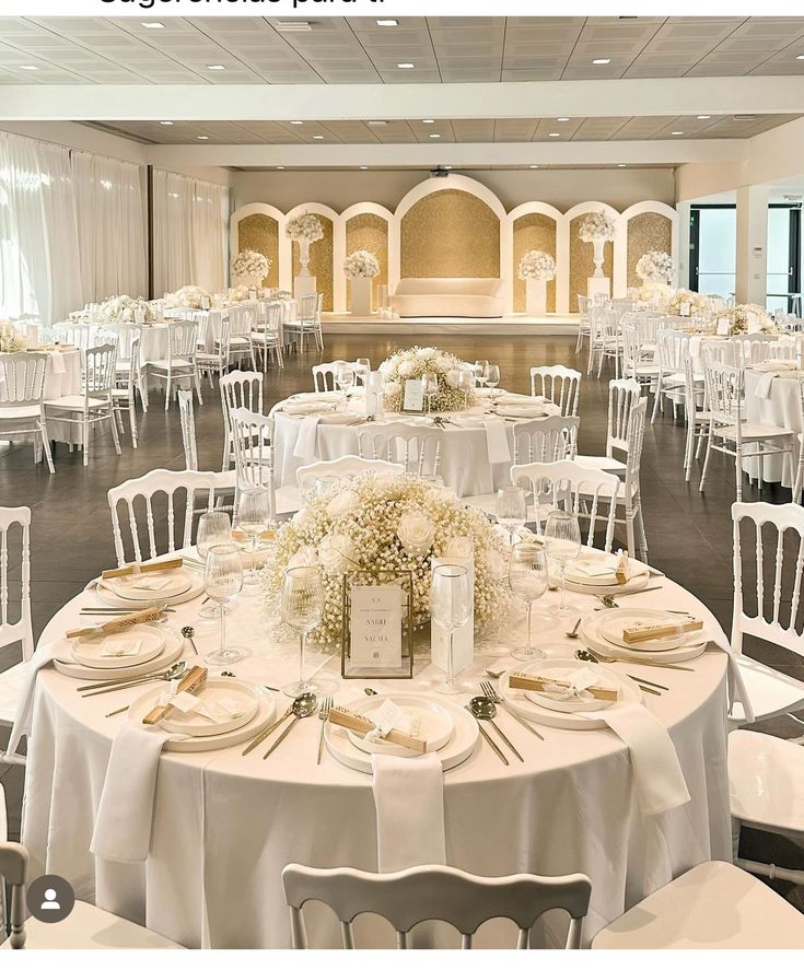 the tables are set with white linens and place settings