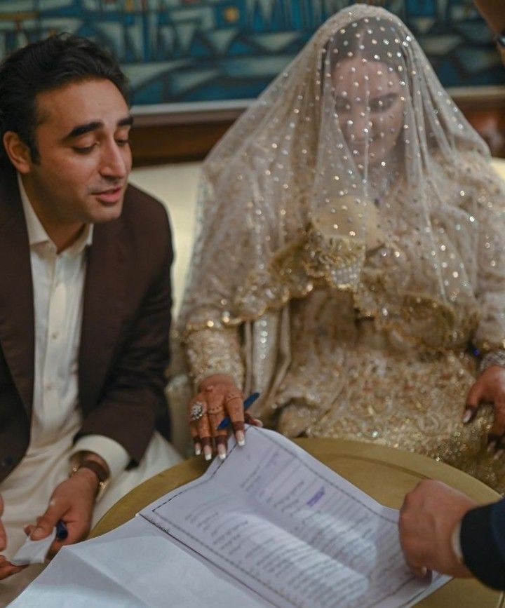 the bride and groom are signing their marriage vows