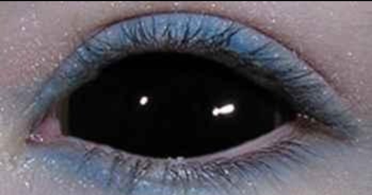 an eye with blue eyeshade and black iris