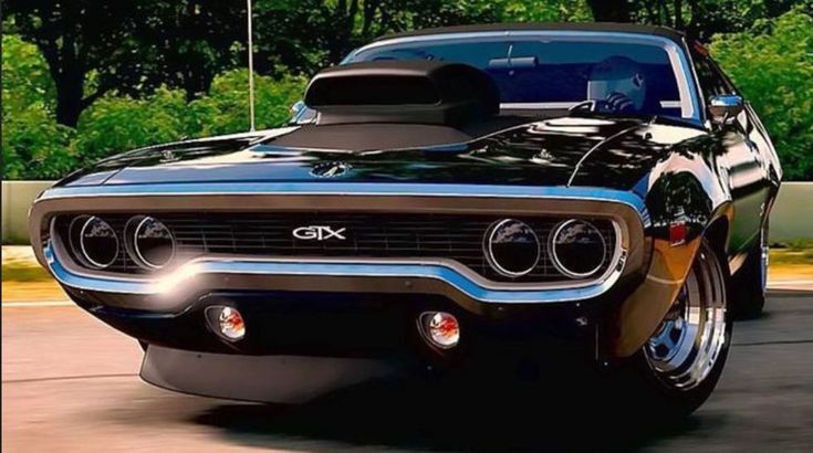 a black and blue muscle car driving down the road