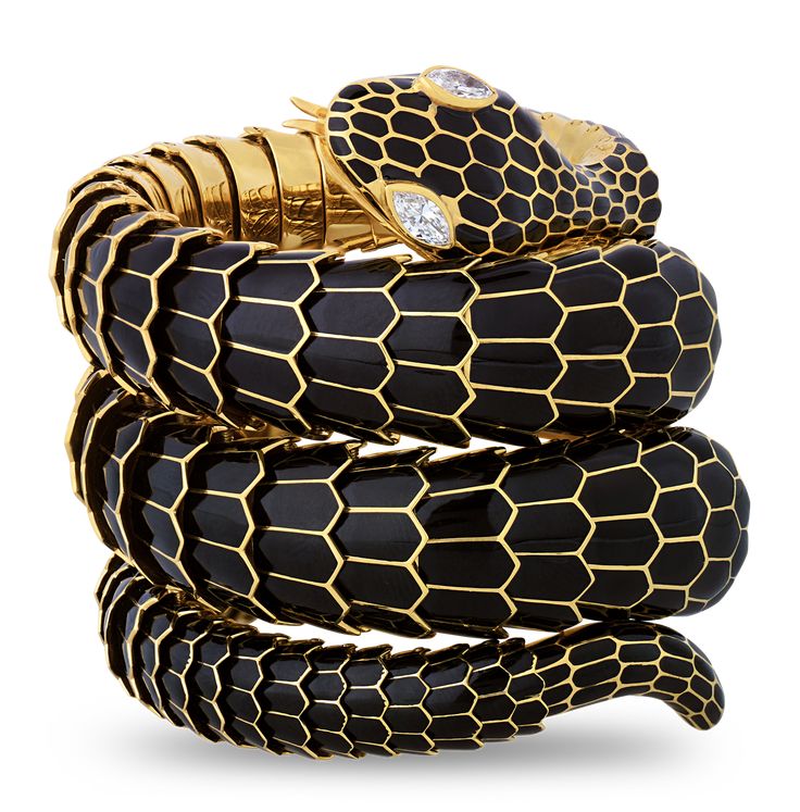 This eye-catching vintage bangle takes the form of a slithering snake. The handcrafted gold and black enamel bracelet perfectly simulates the scaly skin of the captivating reptile, and the serpent's eyes are formed of glittering marquise-cut white diamonds totaling approximately 0.50 carat. Set in 18K yellow gold. 6 3/4" diameter Luxury Snake-shaped Formal Bracelets, Luxury Snake-shaped Party Jewelry, Luxury Formal Snake Bracelet, Luxury Elegant Snake-shaped Bracelet, Luxury Snake Bracelet For Formal Occasions, Luxury Adjustable Snake Shape Bracelets, Luxury Silver Snake-shaped Jewelry, Luxury Elegant Snake-shaped Bracelets, Luxury Vintage Snake-shaped Jewelry