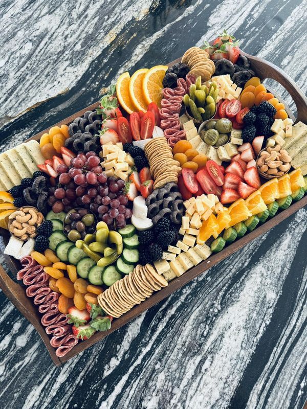 a platter filled with assorted fruit and crackers