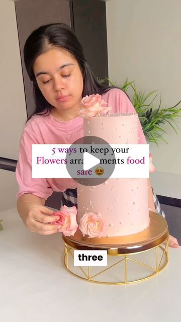 a woman is decorating a pink cake with flowers on it and the words, 5 ways to keep your flower - art meets food