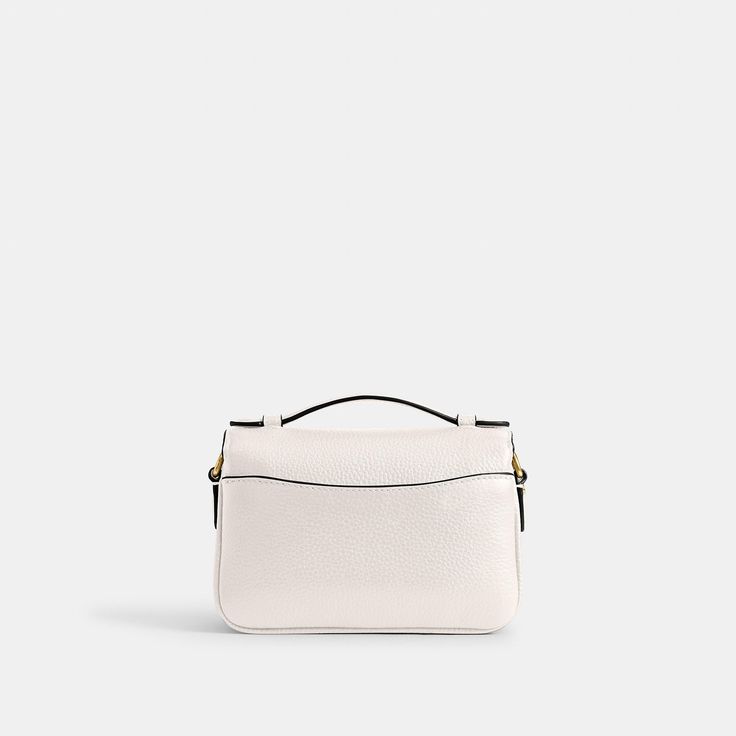 Our structured Cassie crossbody has classic good looks and ample room to hold everyday essentials with three organized compartments. A more compact version of the original the 17 is crafted of refined pebble leather and finished with our iconic turnlock closure. Style the versatile bag three ways: carry by hand with the ladylike top handle wear on the shoulder with the elegant chain strap or crossbody with the adjustable leather strap. | Coach Cassie Crossbody Bag 17 - Women's Designer Crossbody Elegant Double Flap Bag For Daily Use, Classic White Flap Bag, Classic Double Flap Office Bag, Classic Bag With Double Flap For Daily Use, Classic White Shoulder Bag With Turn-lock Closure, Classic Double Flap Bag For Daily Use, Coach Pebbled Leather Satchel With Detachable Strap, Classic Crossbody Satchel With Removable Pouch, Timeless Double Flap Bag With Turn-lock Closure