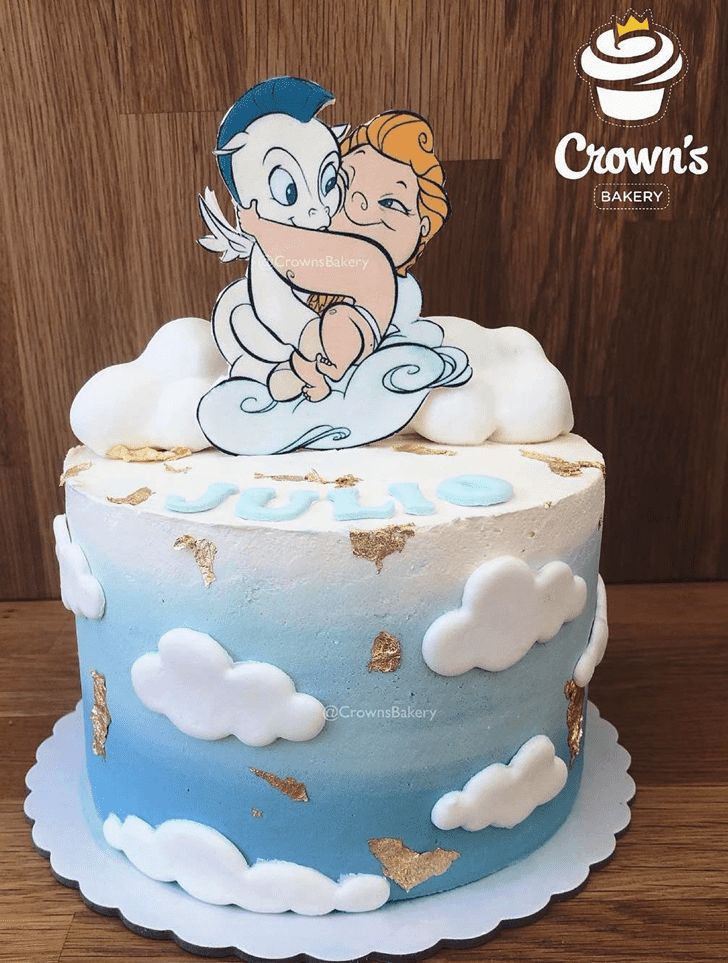 a blue and white cake with an image of a cartoon character on the frosting