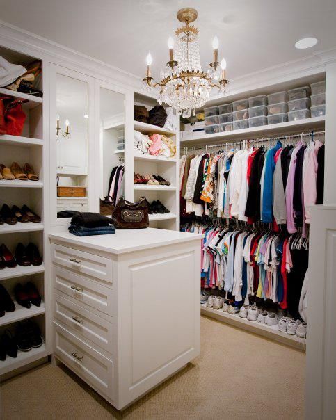 the closet is full of clothes and shoes